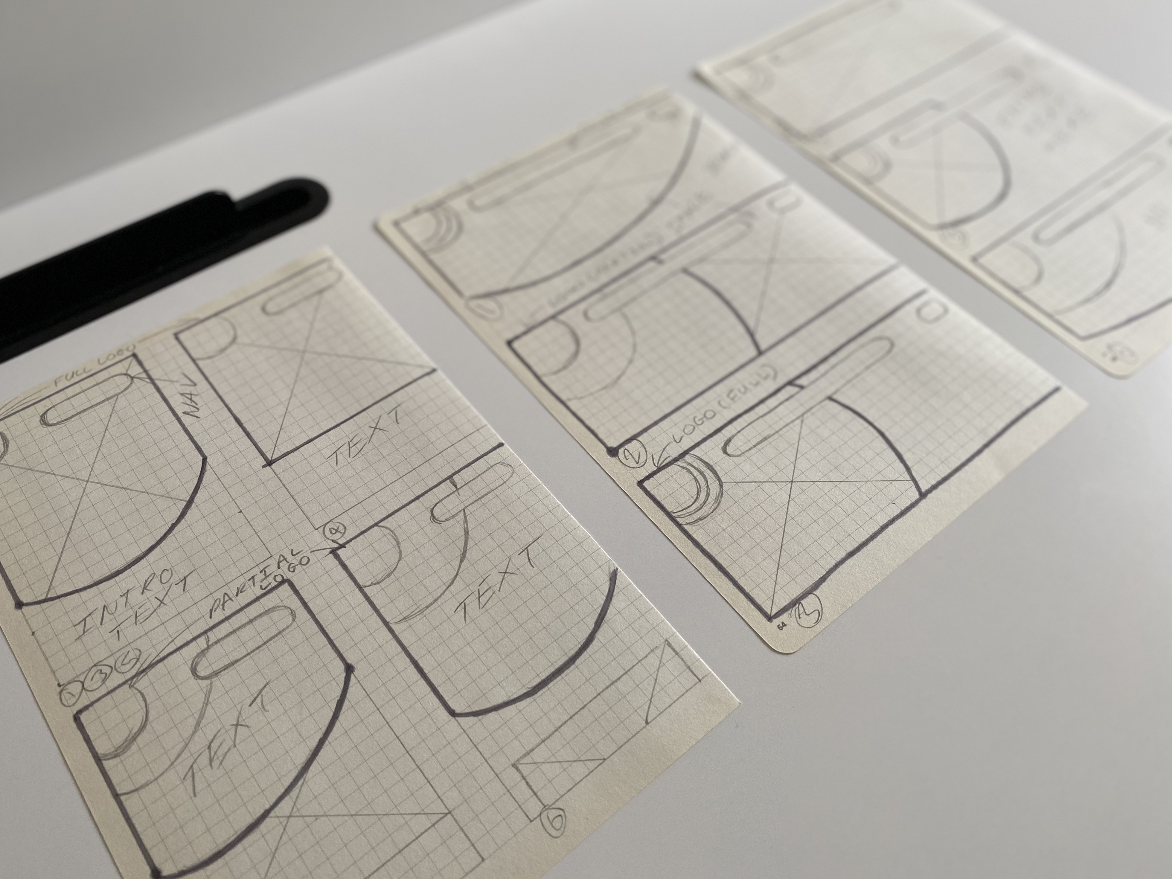 Early sketches exploring how the curved logo motif could repeat across layouts